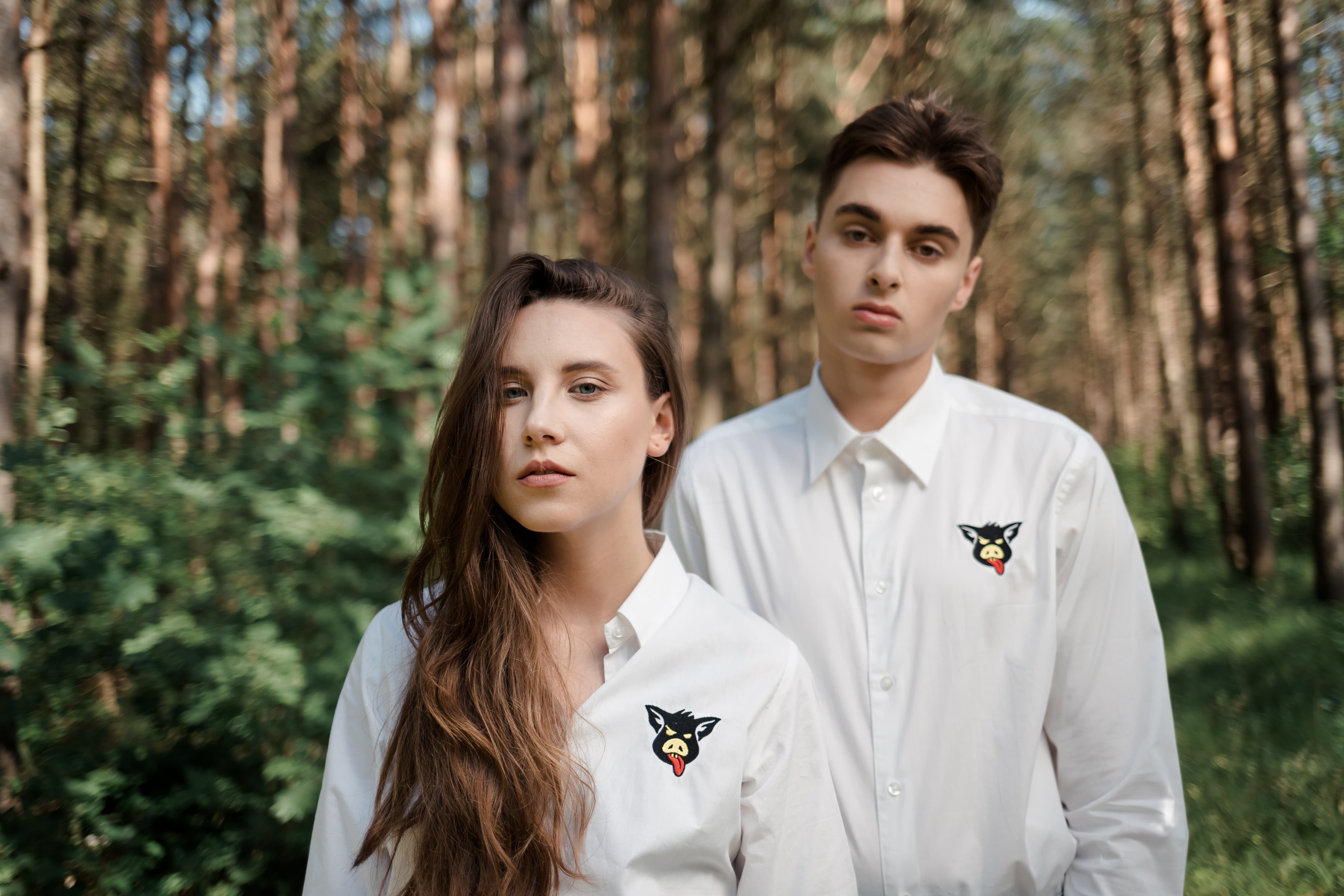 boy and girl in the woods in white shirts